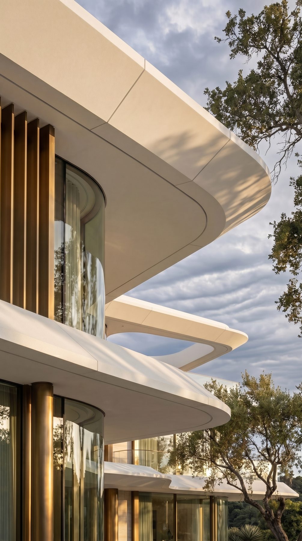 Villa Tosca — sculpted facade curve against the sky, vertical view